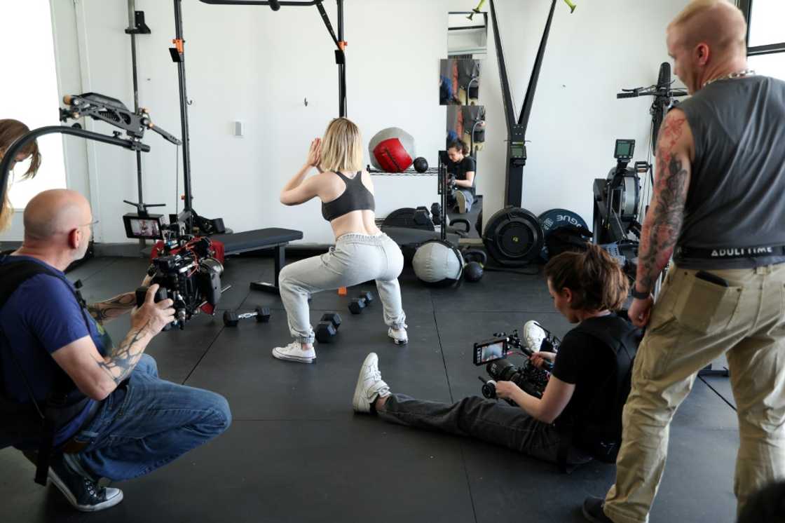 Adult movie director Casey Calvert (seated) and Eli Cross (L) rehearse for a scene with pornographic actress Lilly Bell (C) in Northridge, California Adult movie director Casey Calvert (seated) and Eli Cross (L) rehearse for a scene with pornographic actress Lilly Bell (C) in Northridge, California