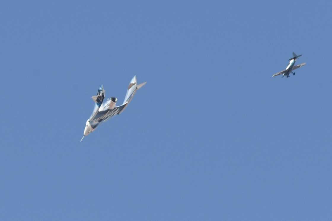 The Virgin Galactic SpaceShipTwo spaceplane Unity and mothership separate as they fly way above Spaceport America in New Mexico in July 2021 on the way to the cosmos