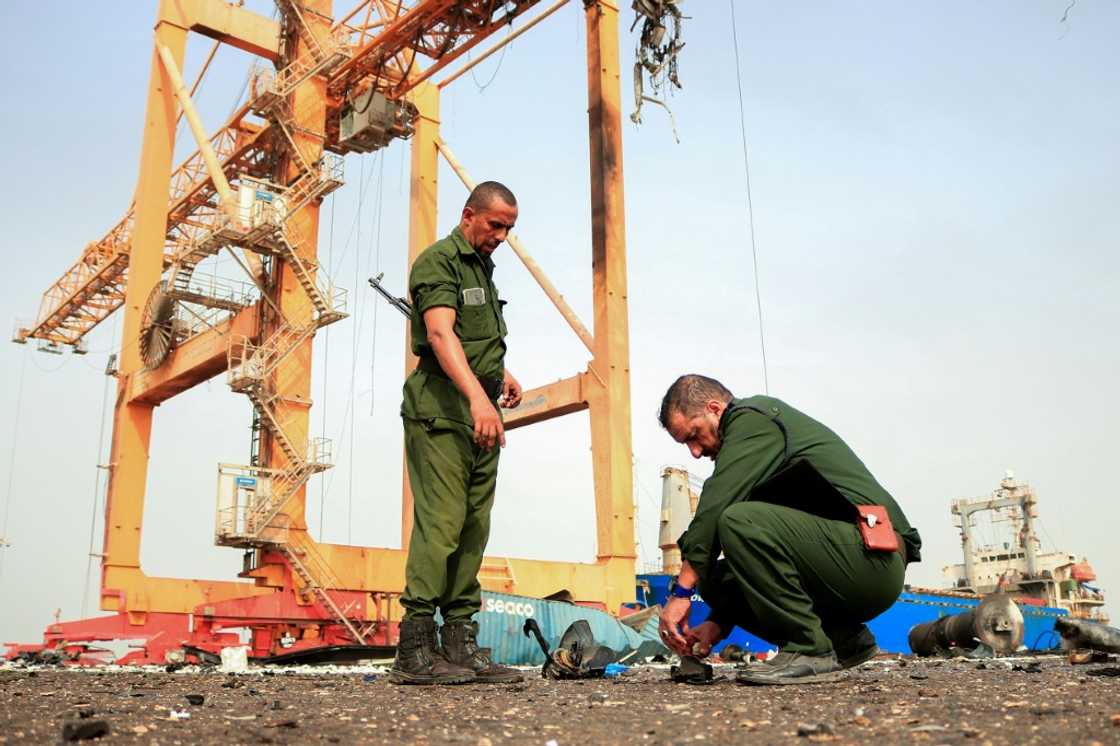 Members of security forces inspect debris on the dock a day after Israeli strikes on Yemen's rebel-held Hodeida port Members of security forces inspect debris on the dock a day after Israeli strikes on Yemen's rebel-held Hodeida port
