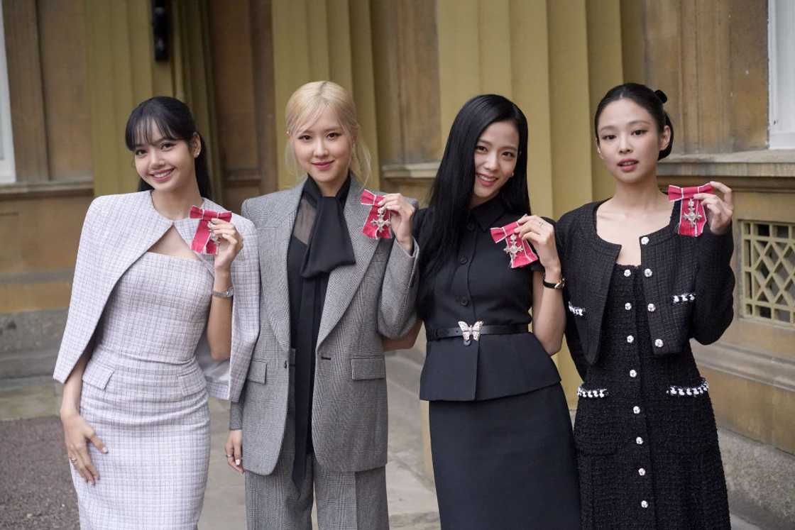 From left to right, Lisa, Rose, Jisoo Kim, and Jennie Kim from the K-pop band Blackpink pose with their Honorary MBEs. From left to right, Lisa, Rose, Jisoo Kim, and Jennie Kim from the K-pop band Blackpink pose with their Honorary MBEs.