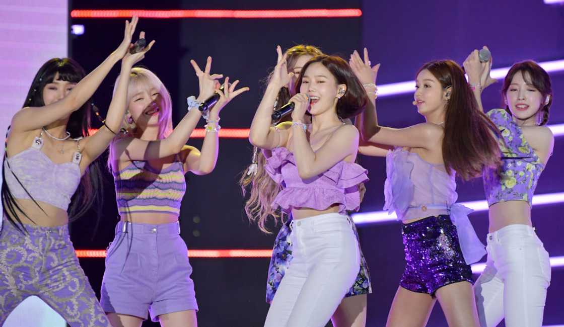 Oh My Girl is a K-pop group performing on stage Oh My Girl is a K-pop group performing on stage