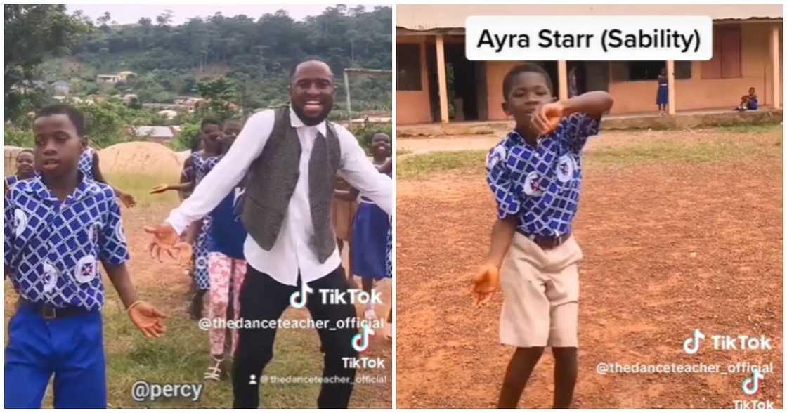 Photo of a Ghanaian teacher and his students