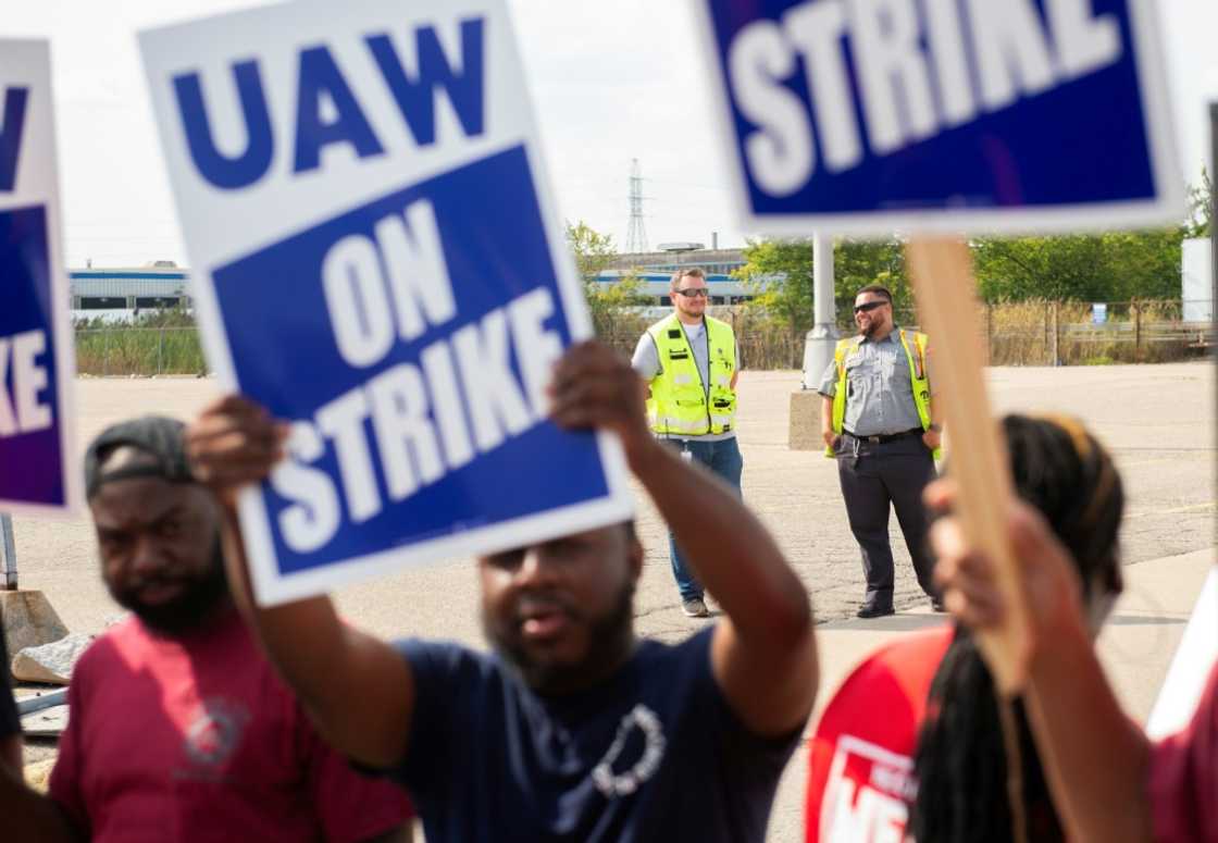 UAW members and workers at Mopar Parts Center Line, a Stellantis parts distribution center in Center Line, Michigan, hold signs after walking off their jobs on September 22, 2023 UAW members and workers at Mopar Parts Center Line, a Stellantis parts distribution center in Center Line, Michigan, hold signs after walking off their jobs on September 22, 2023