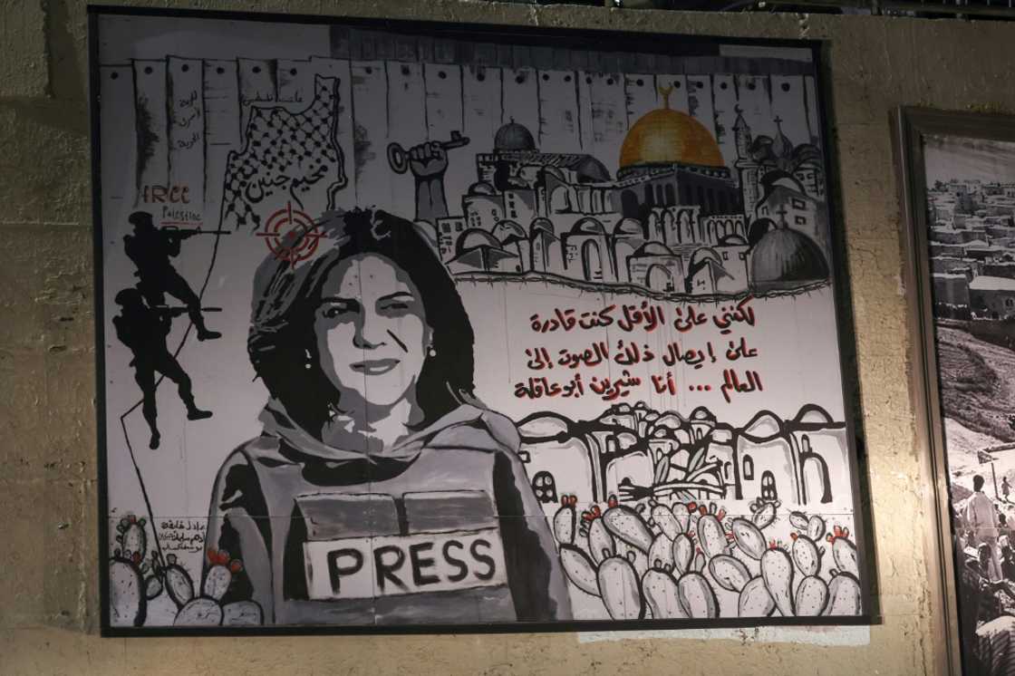 A mural depicting slain Palestinian-American journalist Shireen Abu Akleh is illuminated with headlights on a street in the Arab town of Umm Al-Fahm in northern Israel, on September 5, 2022 A mural depicting slain Palestinian-American journalist Shireen Abu Akleh is illuminated with headlights on a street in the Arab town of Umm Al-Fahm in northern Israel, on September 5, 2022