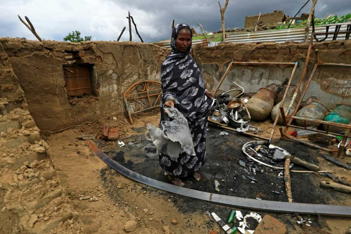 A Sudanese lady stands inside the wreckage of her home torched during clashes in Blue Nile state A Sudanese lady stands inside the wreckage of her home torched during clashes in Blue Nile state