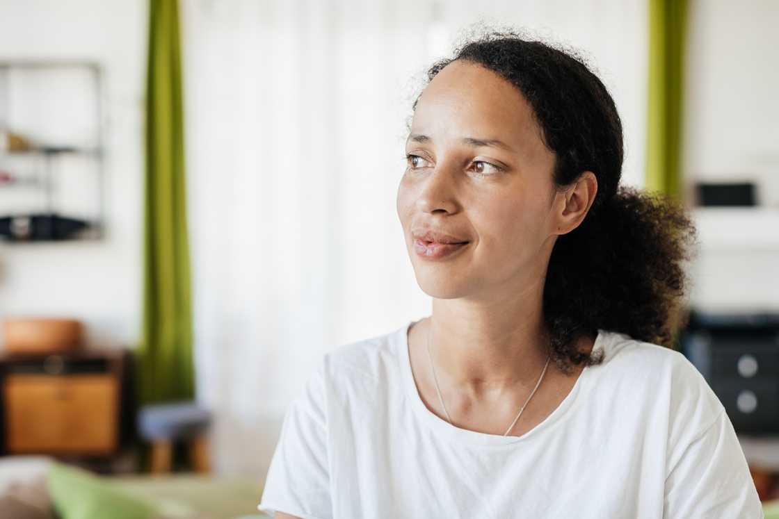 A content lady looks outside the window