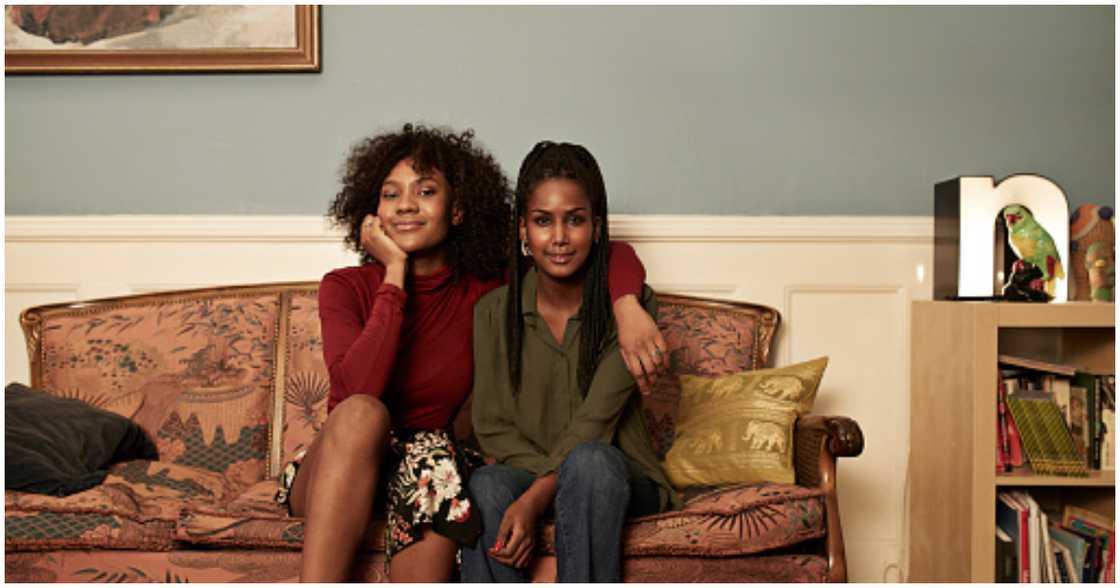 Two roommates pose for a picture Two roommates pose for a picture