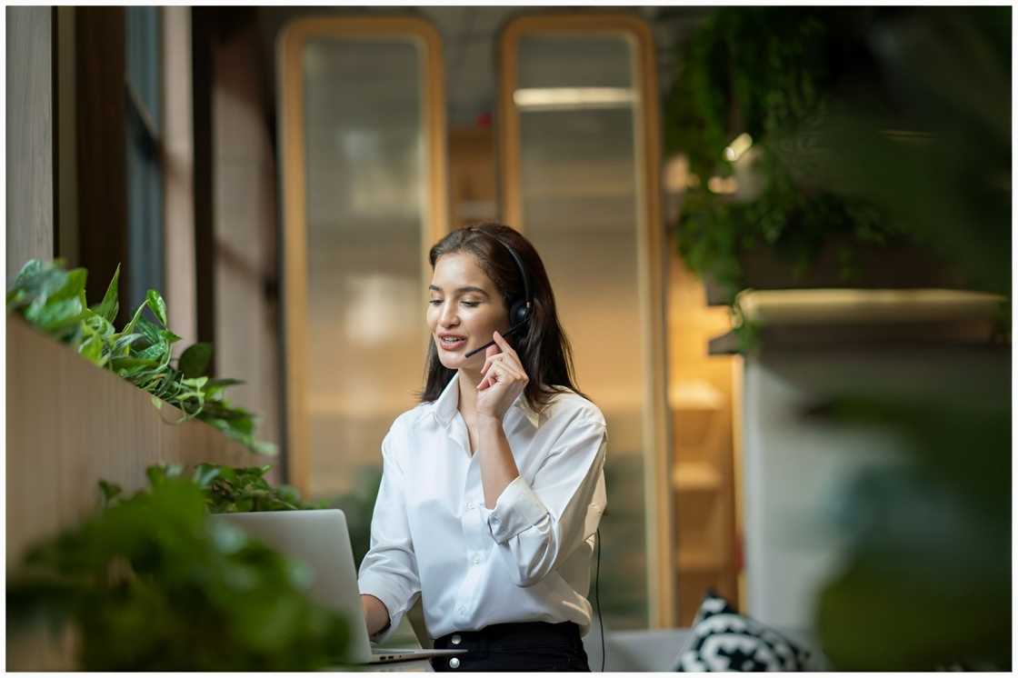 A young woman calls centre support and service customer