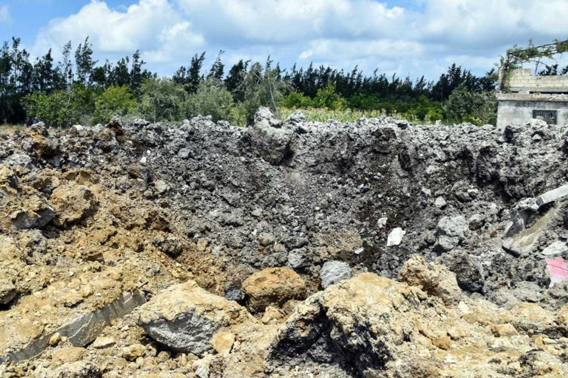 A handout picture released by Syria's official SANA news agency on July 2, 2022, shows a crater caused by a reported Israeli air strike in the western Syrian coastal city of Tartus