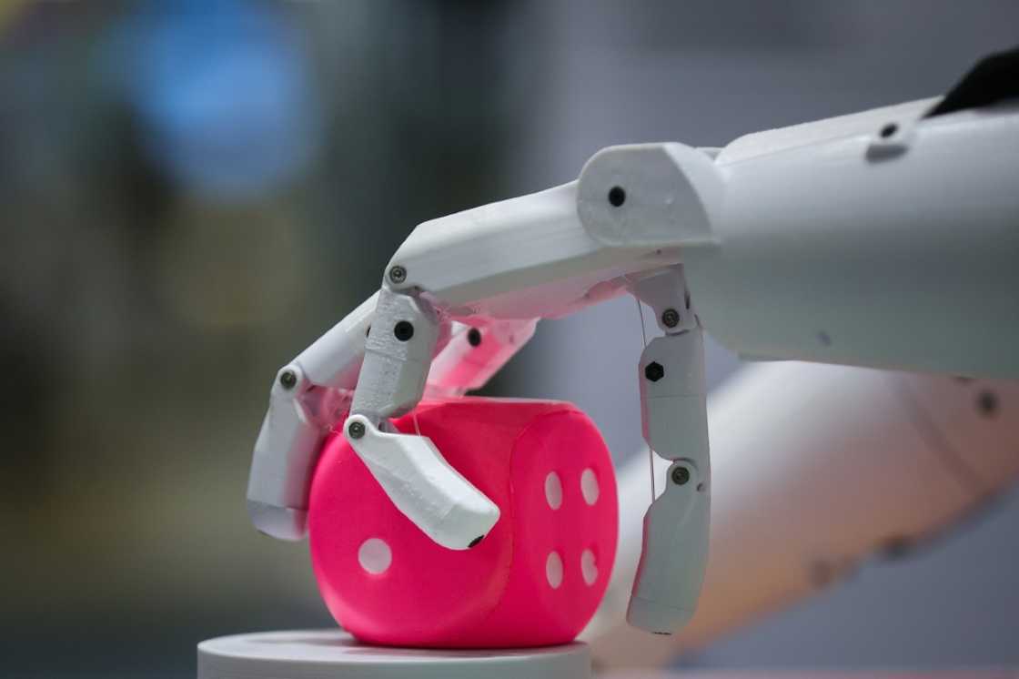 A humanoid robot grabs a cube at the booth of German Federal Ministry of Education and Research A humanoid robot grabs a cube at the booth of German Federal Ministry of Education and Research