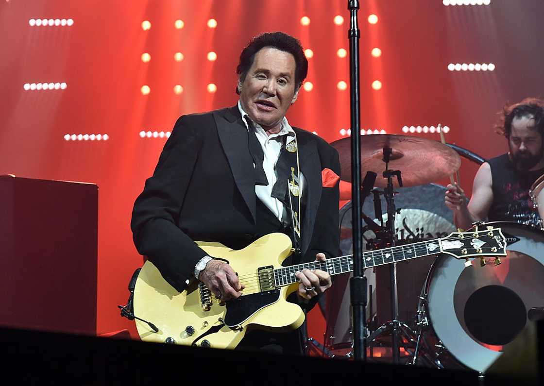 Wayne Newton playing a guitar Wayne Newton playing a guitar