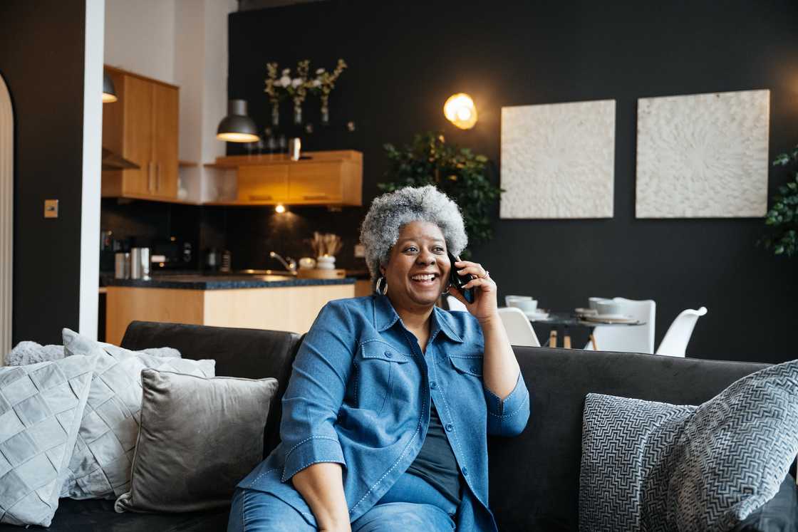 An elderly woman talks on the phone An elderly woman talks on the phone