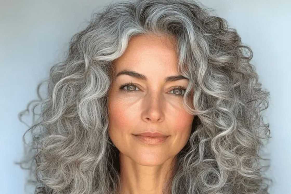 A lovely curly grey hairstyle with a centre part A lovely curly grey hairstyle with a centre part