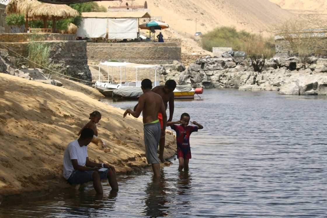 Sudanese who fled the war in their country cool off on the banks of the Nile river in the Egyptian city of Aswan Sudanese who fled the war in their country cool off on the banks of the Nile river in the Egyptian city of Aswan