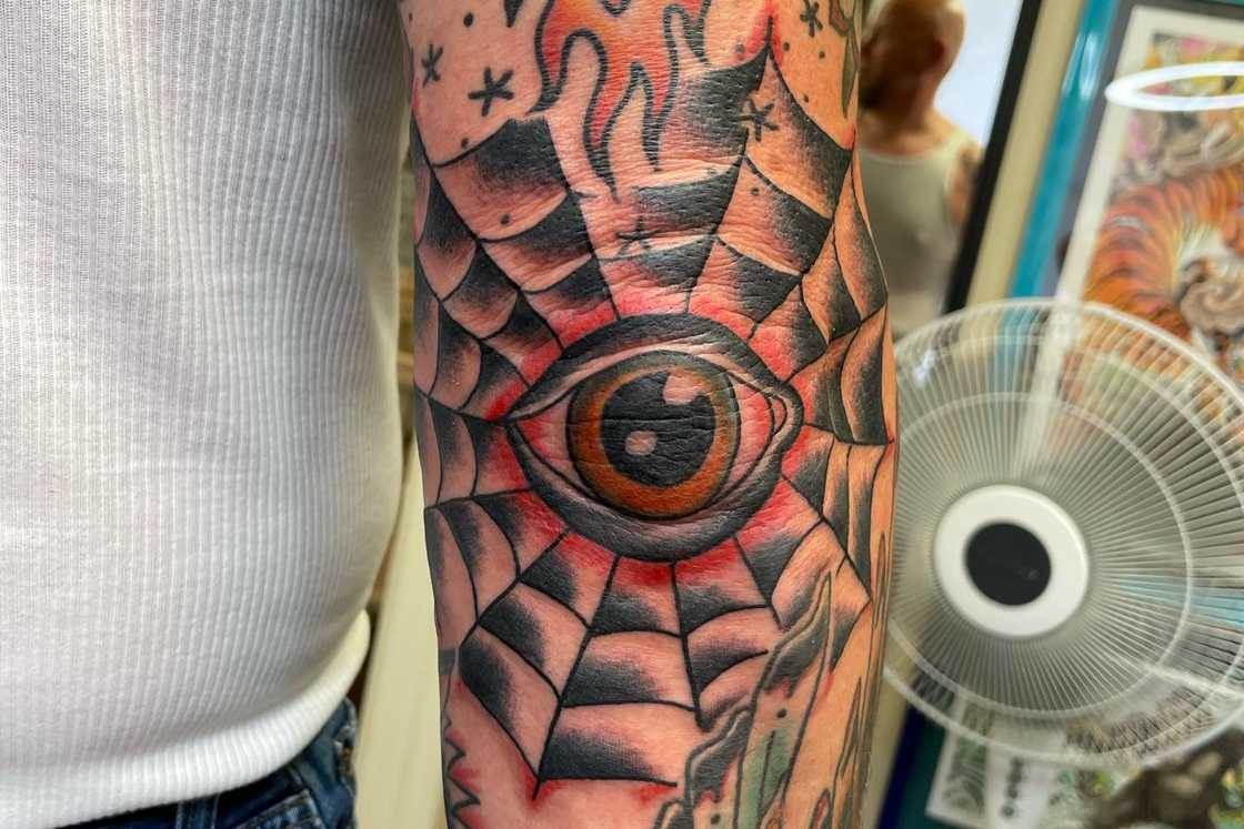 Eye print and spider web elbow tattoo Eye print and spider web elbow tattoo