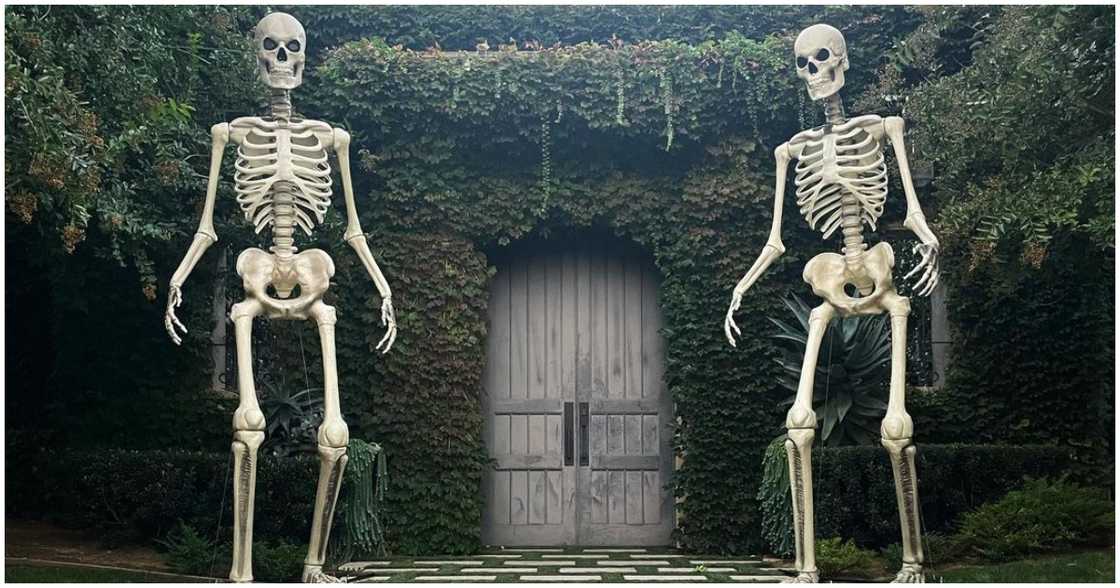 Kourtney's house shows two massive skeletons stationed at the door Kourtney's house shows two massive skeletons stationed at the door