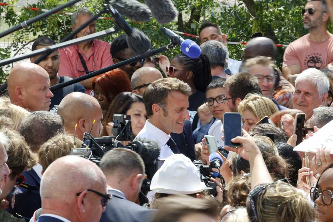 During a walkaboout in Marseille, Macron got into a discussion with a woman about her son's job prospects During a walkaboout in Marseille, Macron got into a discussion with a woman about her son's job prospects