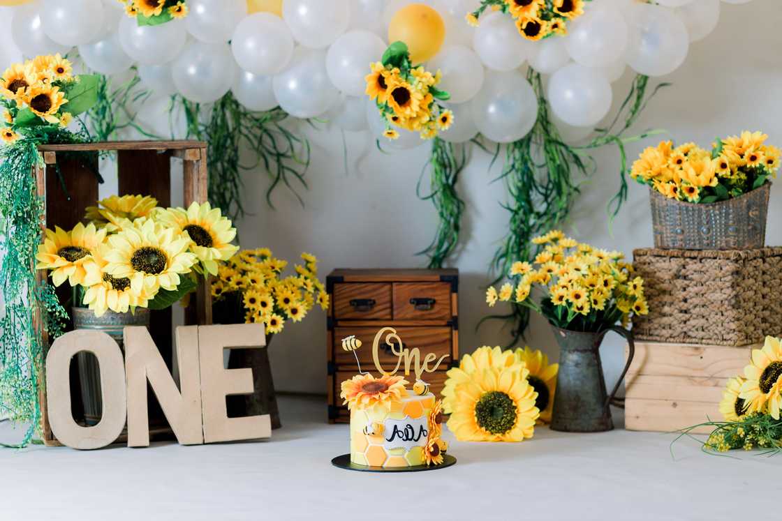 First birthday theme with sunflowers and balloons First birthday theme with sunflowers and balloons