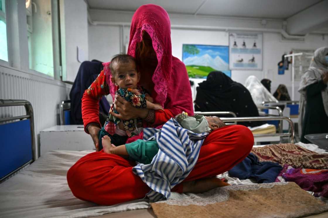 Breshna sits on a hospital bed with her four-month-old twins Subhania and Subhan in the malnutrition ward at a hospital run by Doctors Without Borders (MSF), in Lashkar Gah Breshna sits on a hospital bed with her four-month-old twins Subhania and Subhan in the malnutrition ward at a hospital run by Doctors Without Borders (MSF), in Lashkar Gah