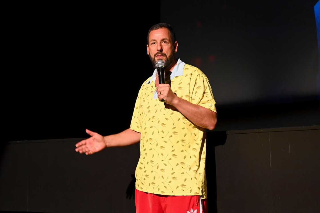 Adam Sandler in speaking on stage