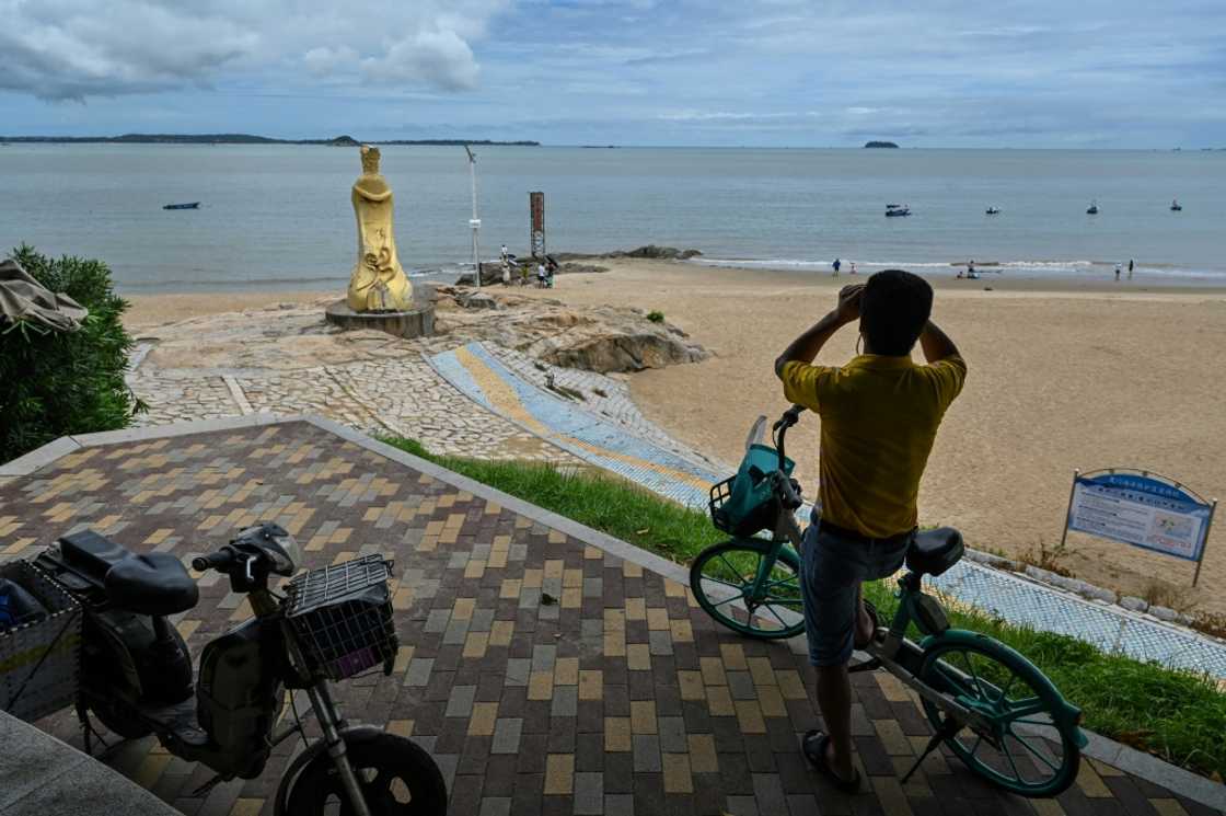 Beachgoers in the Chinese city of Xiamen, just a few kilometres from a Taiwan-controlled island, told AFP they had little fear over the potential for war Beachgoers in the Chinese city of Xiamen, just a few kilometres from a Taiwan-controlled island, told AFP they had little fear over the potential for war