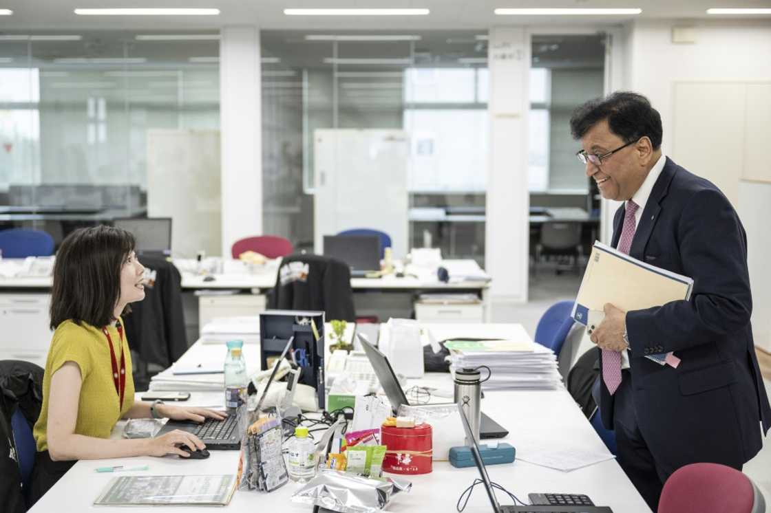 Lekh Juneja chatting with an employee at the company's headquarters in Niigata city, Niigata prefecture