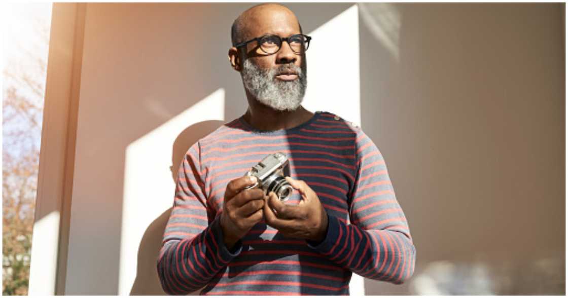 A real estate agent poses with his camera A real estate agent poses with his camera