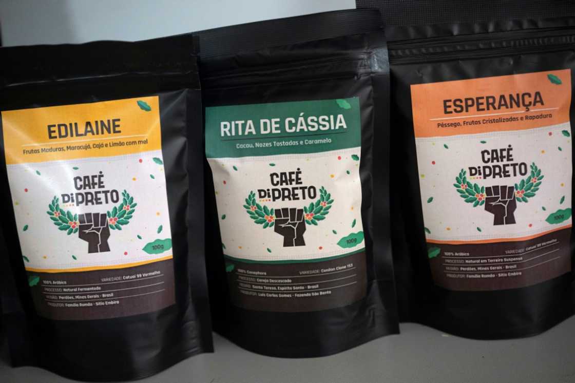 The logo for Cafe di Preto is a raised Black fist clutching a coffee branch The logo for Cafe di Preto is a raised Black fist clutching a coffee branch