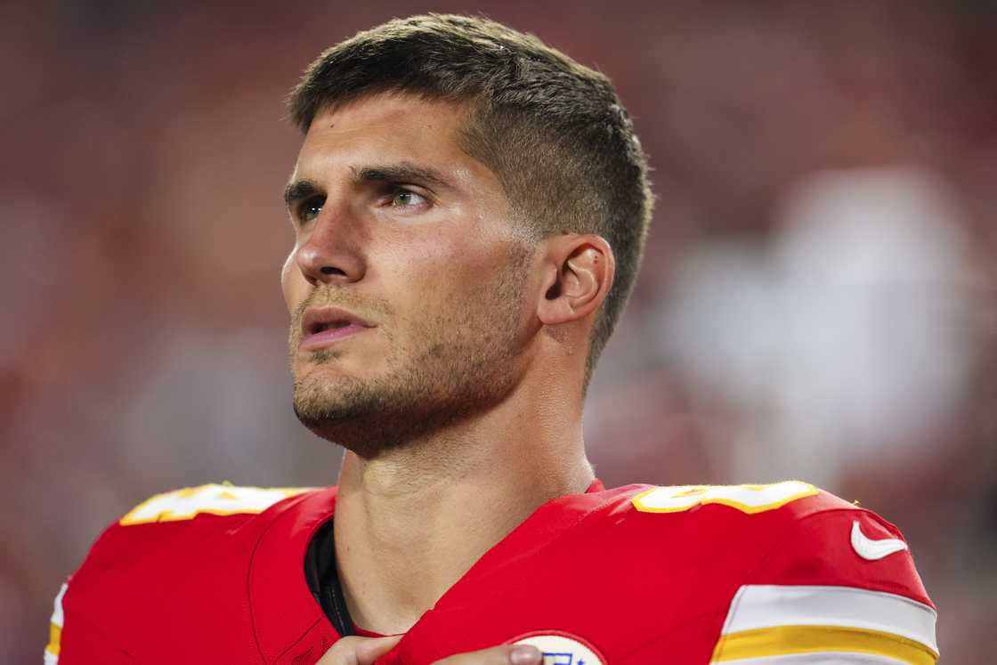 Justin Watson looks on from the sideline before an NFL football game