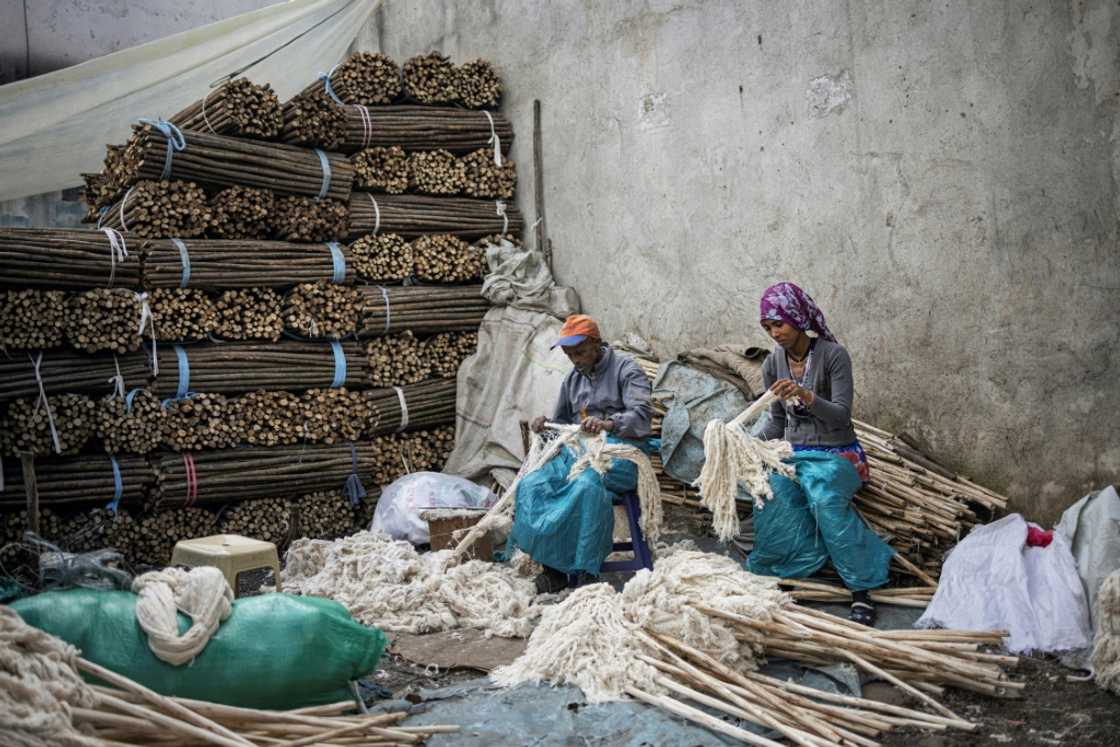 Workers make mops in a street near the Merkato district of Addis Ababa Workers make mops in a street near the Merkato district of Addis Ababa