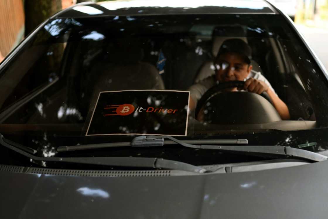 Taxi driver Napoleon Osorio keeps a sign on his car to inform customers that he accepts bitcoin payments