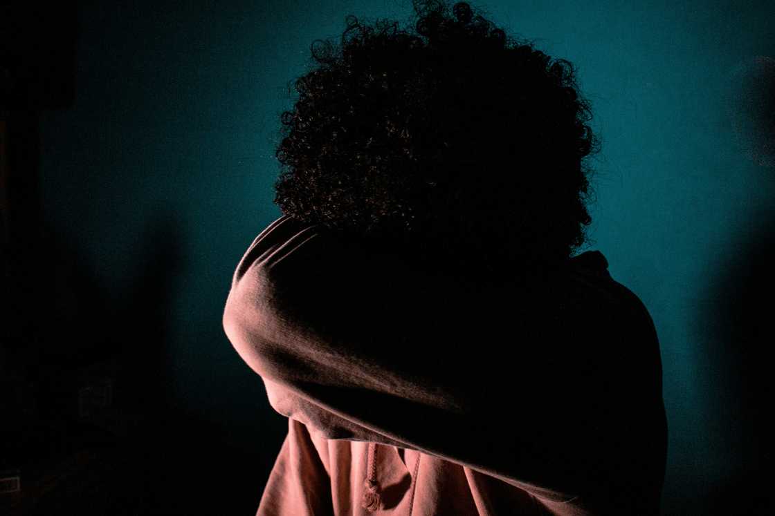 A stressed girl in a dark room A stressed girl in a dark room