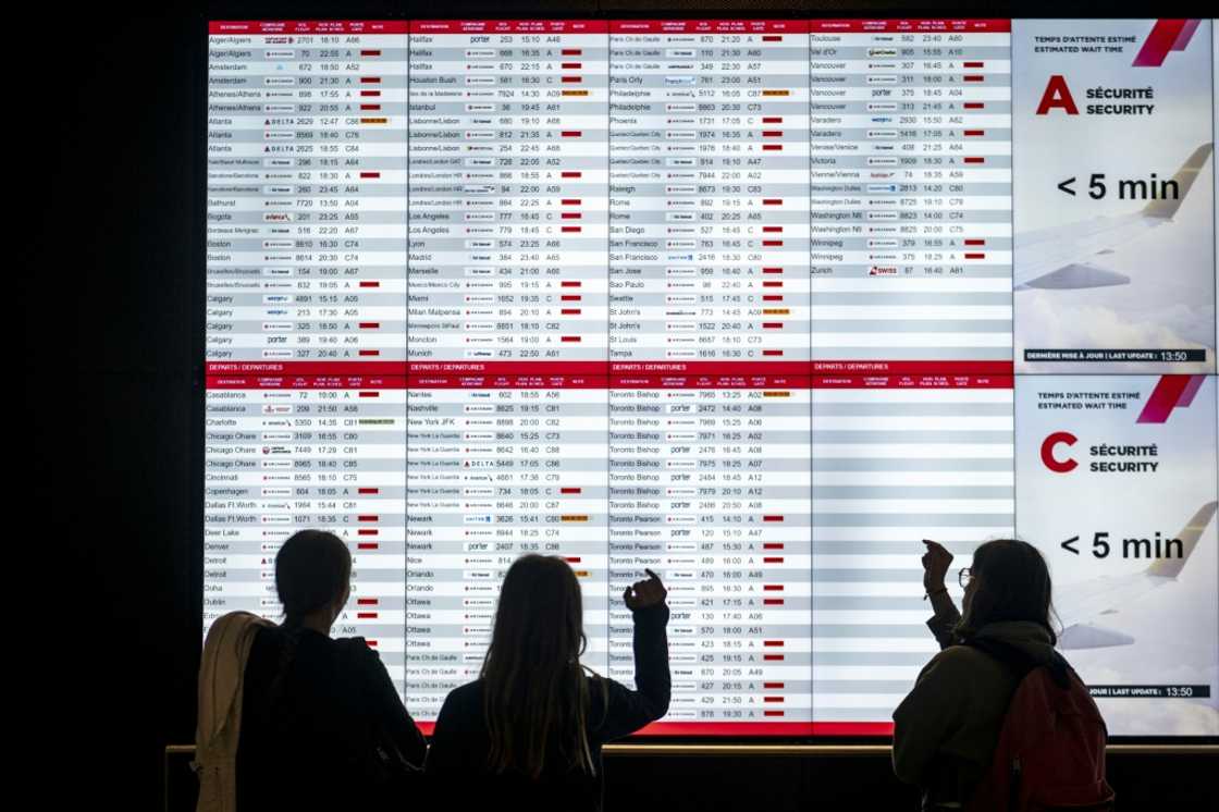 Passengers looking at a depatures in Montreal, Canada, during the Air Canada strike Passengers looking at a depatures in Montreal, Canada, during the Air Canada strike