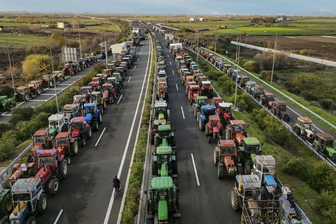 Farmers block the highway outside the central Greek city of Karditsa on December 8, 2025 to demand swifter access to EU subsidies