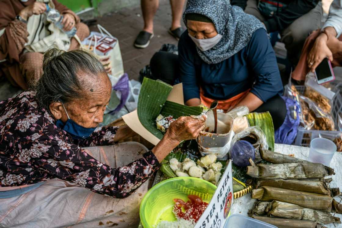 Septuagenarian Mbah Satinem (L) charges 10,000 rupiah ($0.67) for a serving of the lupis her mother taught her to make Septuagenarian Mbah Satinem (L) charges 10,000 rupiah ($0.67) for a serving of the lupis her mother taught her to make