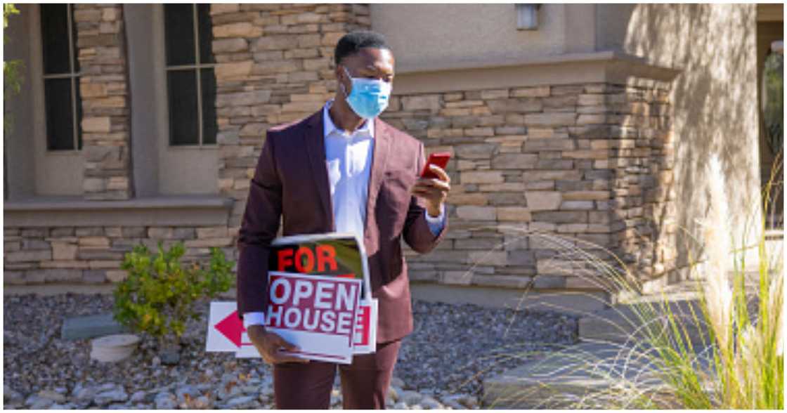 A landlord checks his phone for messages from tenants