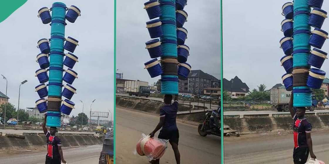 Nigerian man carries 20 coolers on his head. Nigerian man carries 20 coolers on his head.