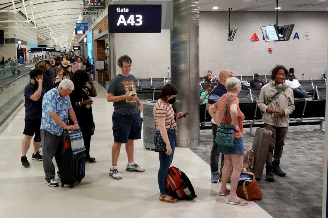 Travelers wait in a long line to speak with a Delta representative at the help desk in the McNamara terminal at the Detroit Metropolitan Wayne County Airport on July 20, 2024 Travelers wait in a long line to speak with a Delta representative at the help desk in the McNamara terminal at the Detroit Metropolitan Wayne County Airport on July 20, 2024
