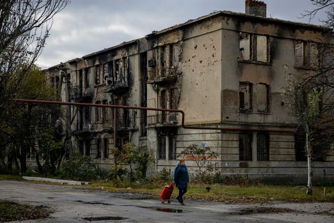 A woman walks past a damaged building in Lyman in the Donetsk region of Ukraine after the recapture of the area from Russian forces A woman walks past a damaged building in Lyman in the Donetsk region of Ukraine after the recapture of the area from Russian forces
