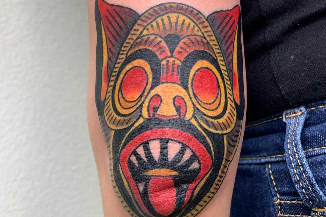 Fun vintage style mask elbow tattoo Fun vintage style mask elbow tattoo