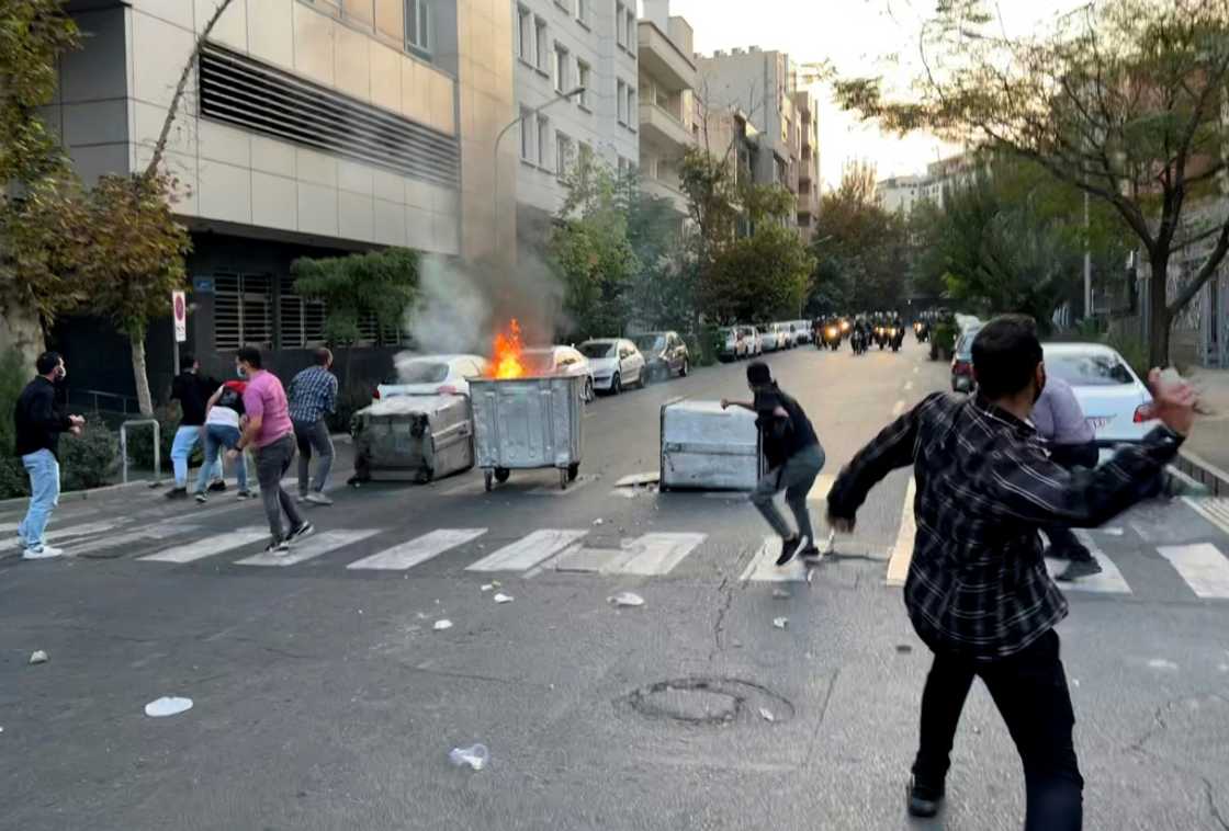 A picture obtained by AFP outside Iran shows a bin burning in a Tehran street during the protests over Mahsa Amini's death A picture obtained by AFP outside Iran shows a bin burning in a Tehran street during the protests over Mahsa Amini's death