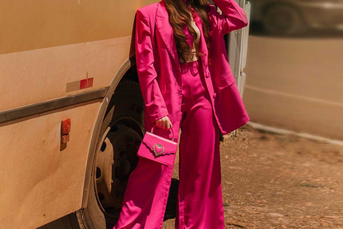 A lady is wearing a stylish barbiecore cowgirl outfit. A lady is wearing a stylish barbiecore cowgirl outfit.