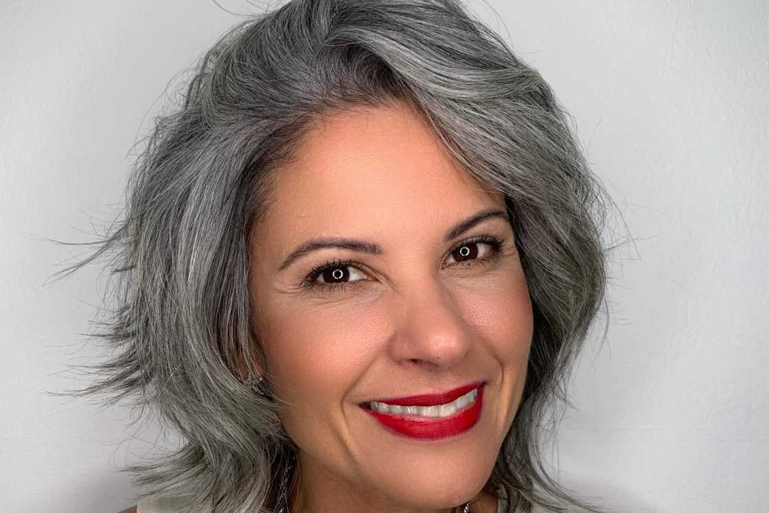 A young woman rocks a side-swept salt and pepper shag A young woman rocks a side-swept salt and pepper shag