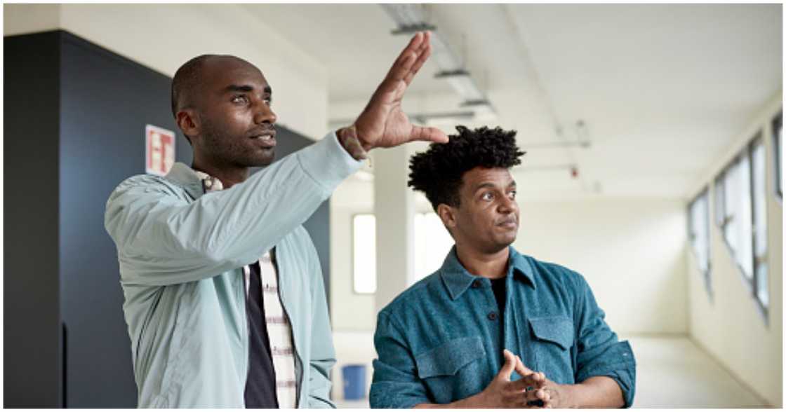 Property owner shows a potential buyer around his property Property owner shows a potential buyer around his property