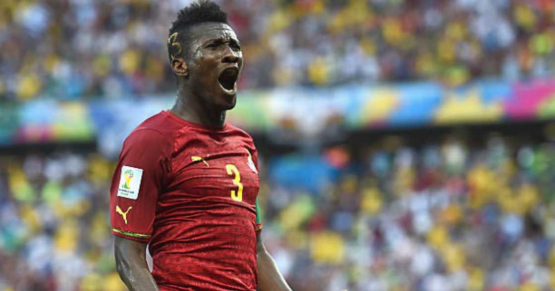 Asamoah Gyan celebrates after scoring.