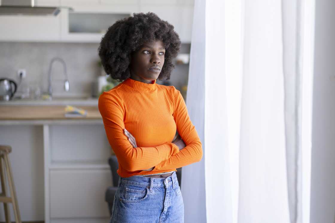 A serious young woman is standing A serious young woman is standing