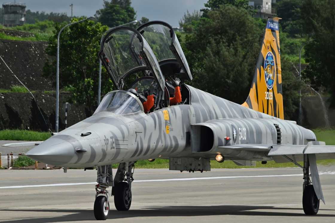 Pilots in a US-made Taiwanese Air Force F-5F Tiger II fighter-jet wave during a demonstration at an air force base in Taitung, eastern Taiwan, in July 2022