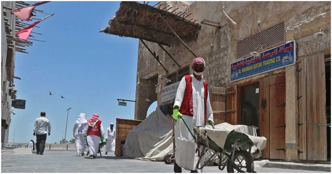 Members of staff wearing masks work at Qatar's touristic Souq Waqif bazar in the capital Doha, on May 17, 2020.