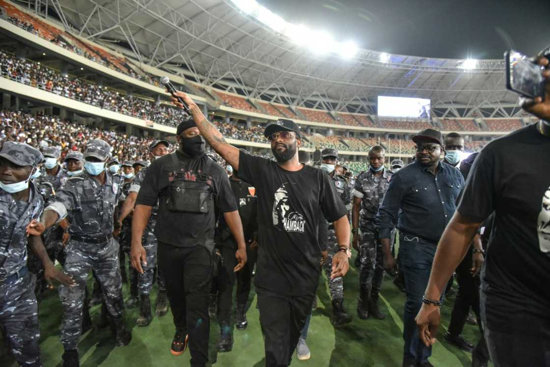 Fally Ipupa has a police escort leaving Abidjan's Olympic stadium in March last year Fally Ipupa has a police escort leaving Abidjan's Olympic stadium in March last year