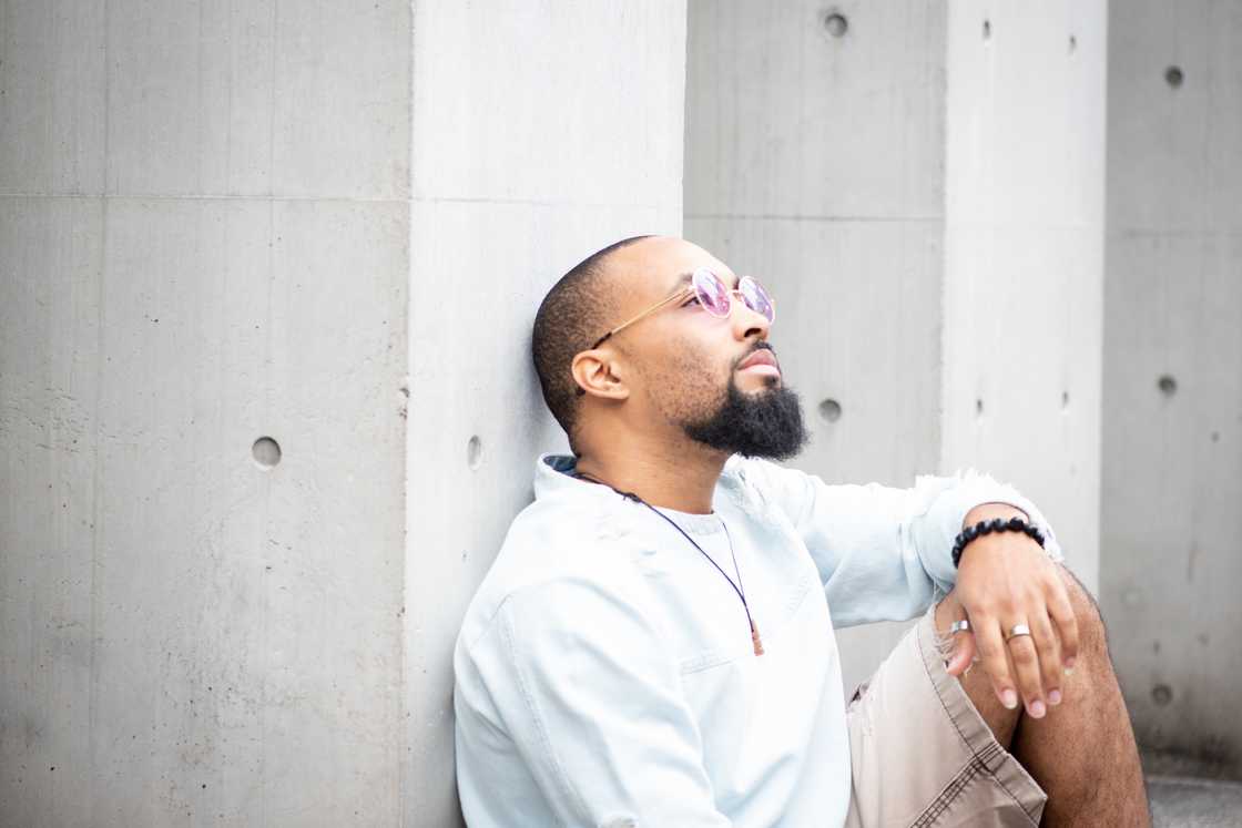 A man sitting outside on a sunny day, relaxing. A man sitting outside on a sunny day, relaxing.